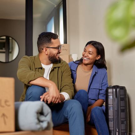 A couple on the steps surrounded by boxes
