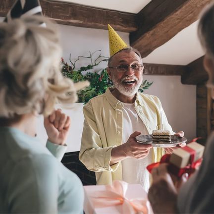A group surprising a man at a birthday party