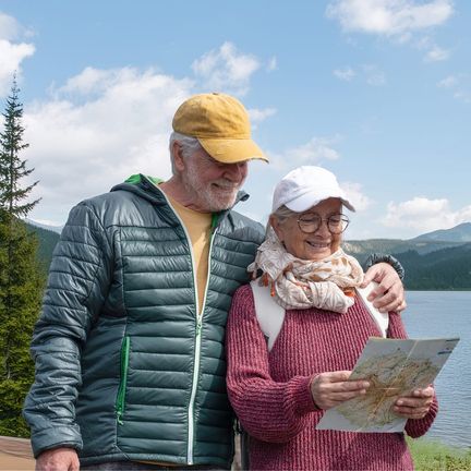 Senior couple with a map in the mountains