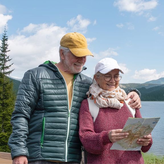 Senior couple with a map in the mountains